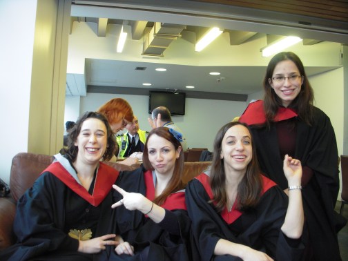 Sporting our graduation gowns in the library cafe.