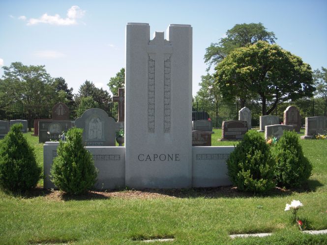 The gravesite of the Capone family; individual family markers lay in the ground before it.